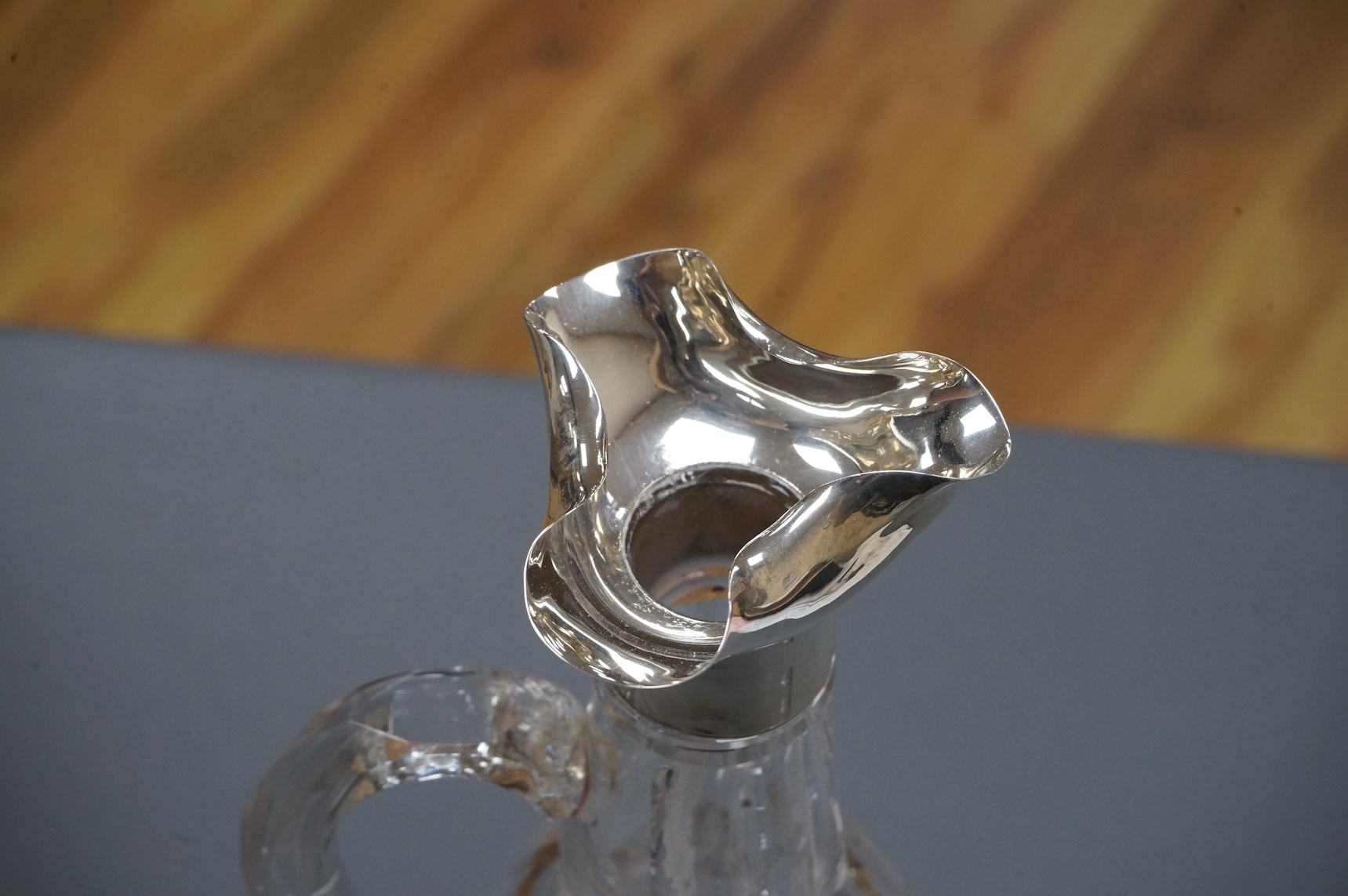 An Edwardian silver mounted cut glass bell shaped single handled decanter, with stopper, by Thomas Webb & Sons Ltd, London, 1902, 34.2cm.